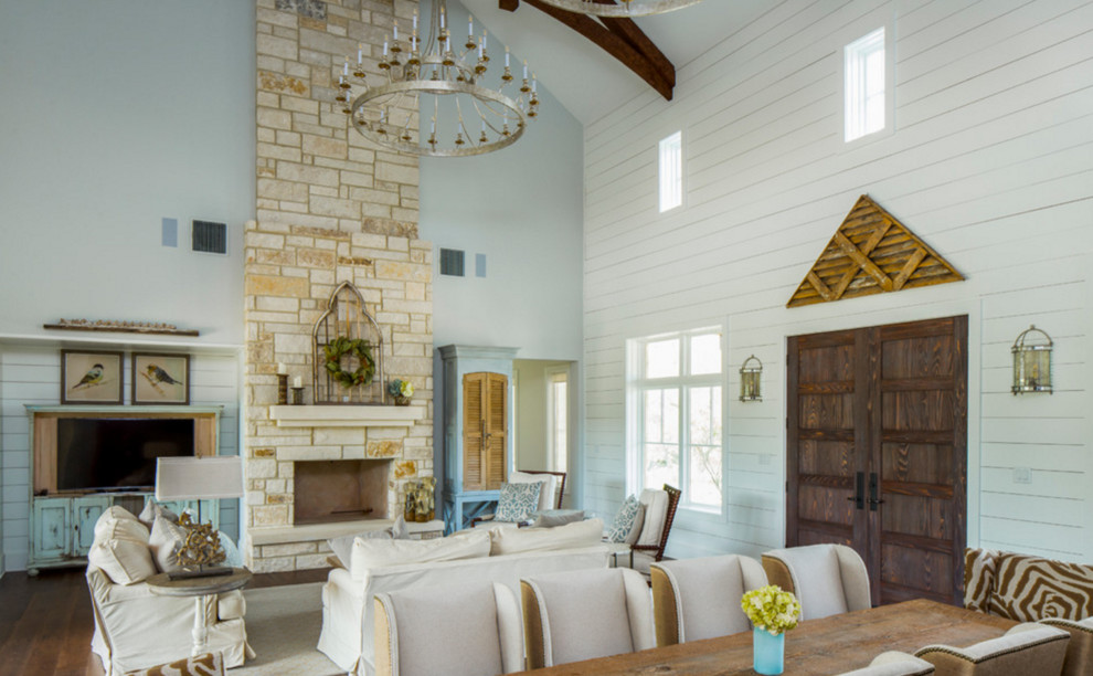 Photo of a large rustic formal open plan living room in Austin with white walls, dark hardwood flooring, a standard fireplace, a stone fireplace surround and a built-in media unit.
