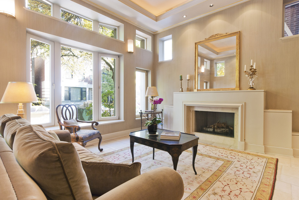 Example of a classic living room design in Chicago with beige walls and a standard fireplace