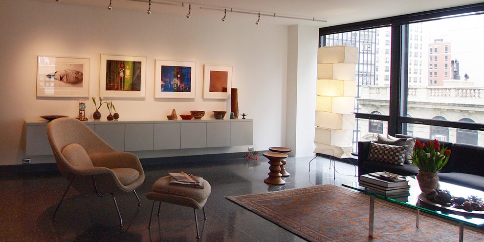 Example of a large minimalist loft-style concrete floor and gray floor living room design in Chicago with white walls