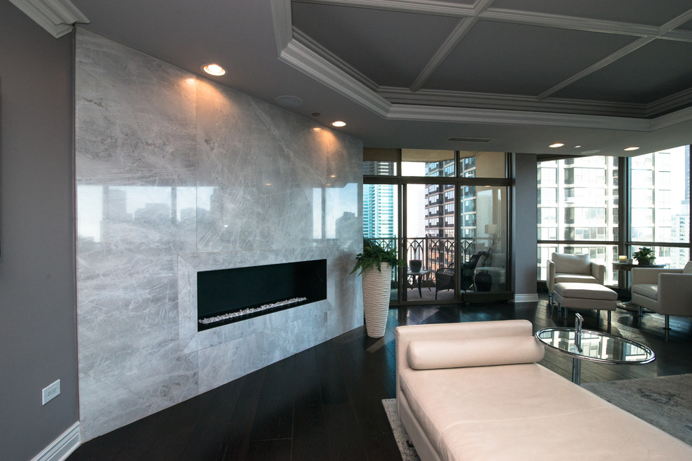 This is an example of a large contemporary open plan living room in Chicago with grey walls, dark hardwood flooring, a ribbon fireplace, a tiled fireplace surround and a wall mounted tv.