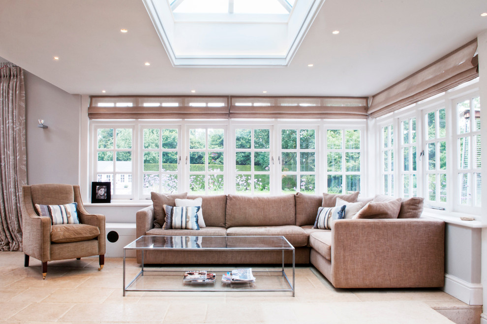 Example of a transitional formal living room design in Surrey with gray walls