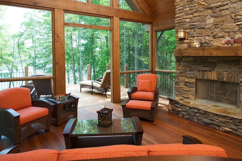 This is an example of a rustic living room in Other with a standard fireplace, a stone fireplace surround and no tv.