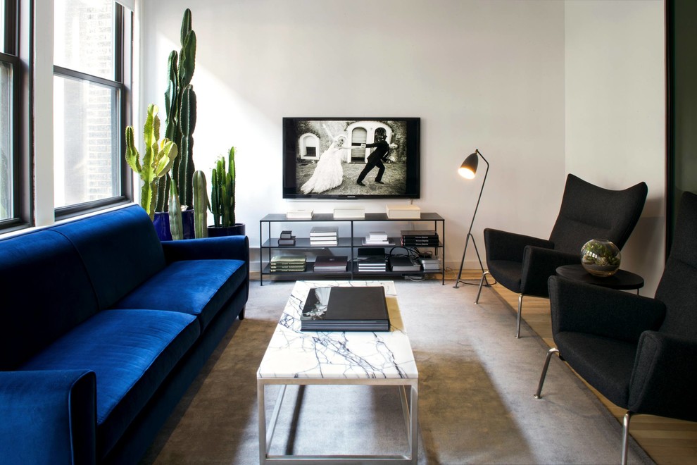 Living room - mid-sized contemporary open concept light wood floor and beige floor living room idea in New York with white walls, a wall-mounted tv and no fireplace