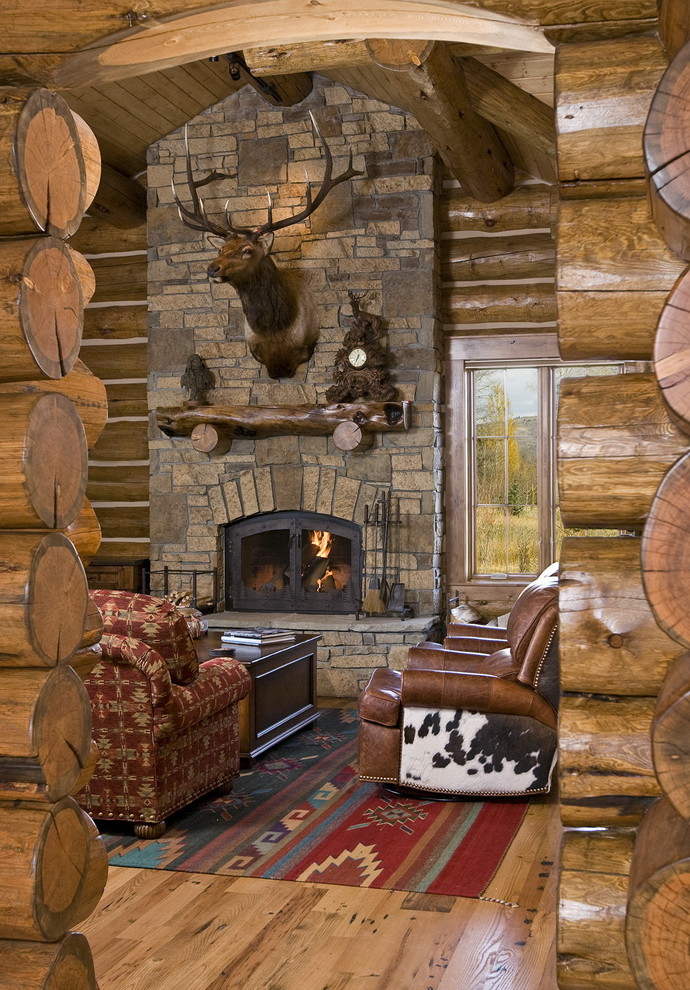 Photo of a rustic living room in Other with a standard fireplace, a stone fireplace surround and no tv.