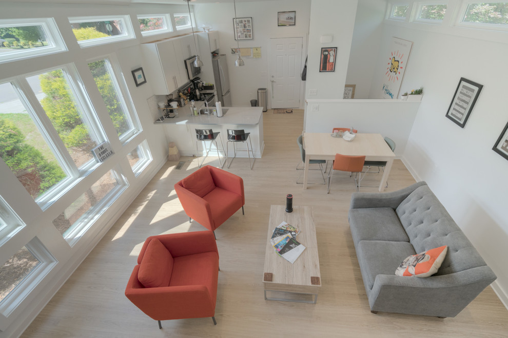 Imagen de salón abierto moderno pequeño con paredes blancas, suelo vinílico, televisor colgado en la pared y suelo beige