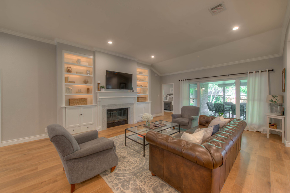 Example of a large transitional open concept medium tone wood floor living room design in Austin with gray walls, a standard fireplace, a tile fireplace and a wall-mounted tv