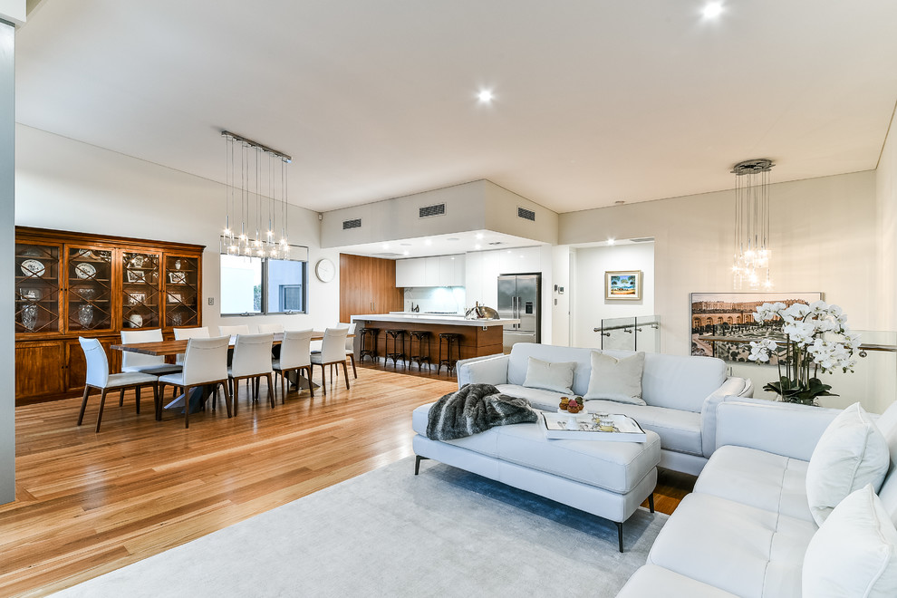 Example of a large trendy open concept medium tone wood floor living room design in Perth with yellow walls, a ribbon fireplace, a brick fireplace and a wall-mounted tv