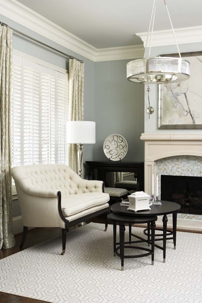 Example of a mid-sized transitional formal and enclosed medium tone wood floor living room design in Other with a tile fireplace, gray walls, a standard fireplace and no tv