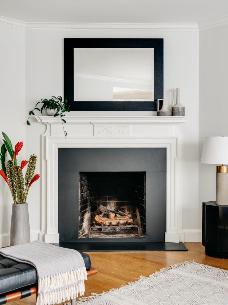Living room - mid-sized transitional formal and open concept medium tone wood floor and brown floor living room idea in San Francisco with gray walls, a corner fireplace, a wood fireplace surround and a wall-mounted tv