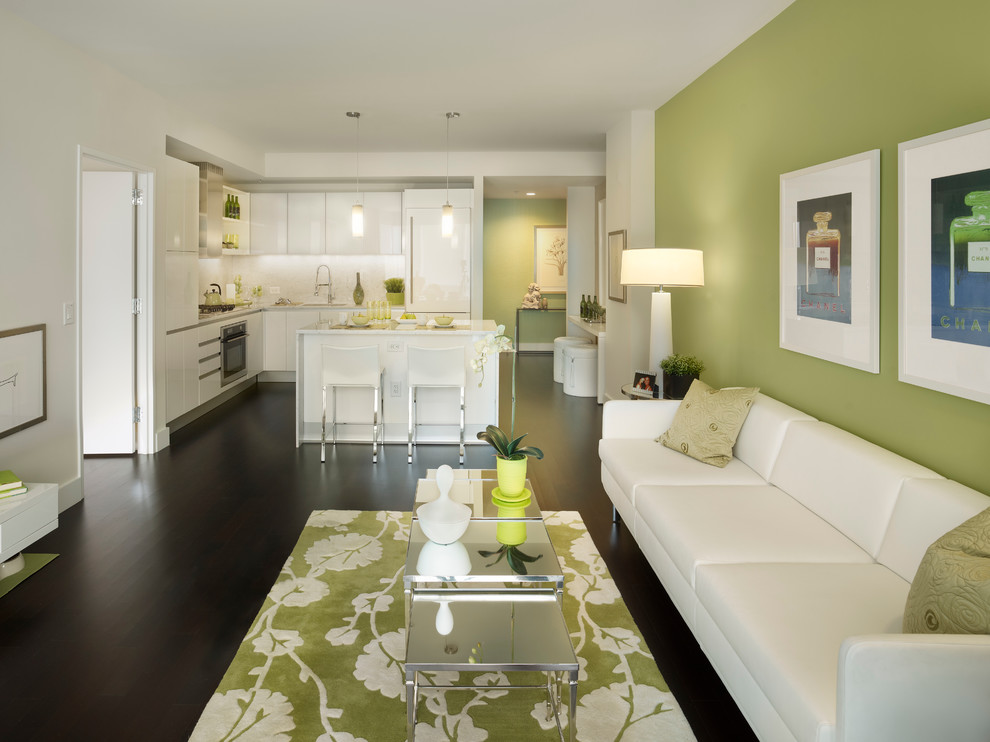 Example of a trendy open concept dark wood floor and black floor living room design in New York with green walls