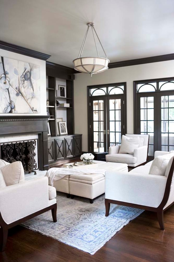 Example of a large classic enclosed dark wood floor living room design in Other with white walls, a standard fireplace and no tv