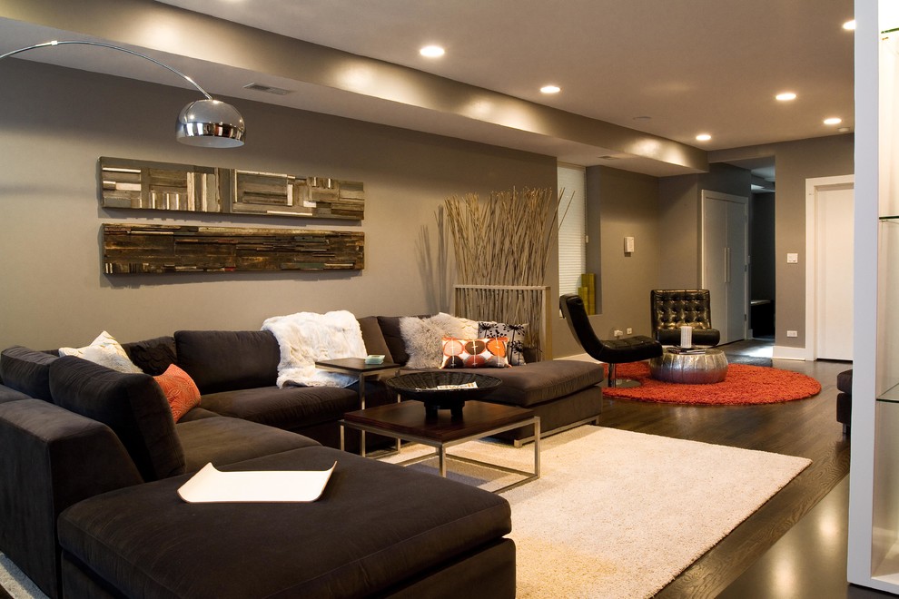 Example of a large minimalist formal and open concept dark wood floor living room design in Chicago with no fireplace, a media wall and gray walls