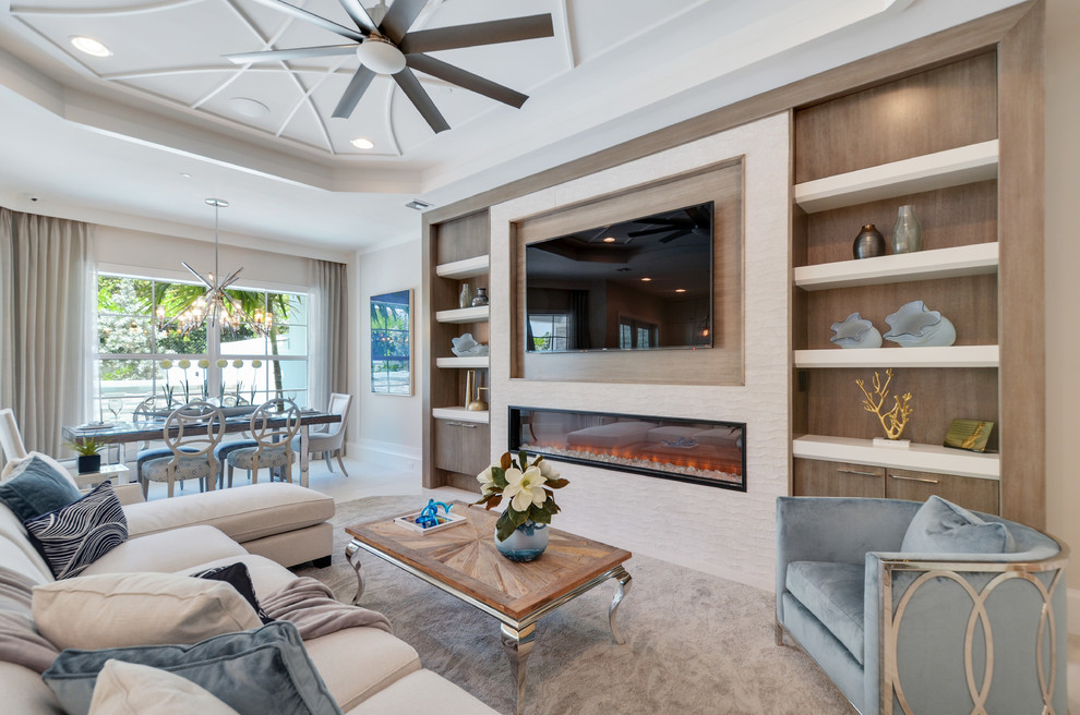 This is an example of a large classic enclosed living room in Miami with white walls, laminate floors, a wall mounted tv, blue floors and a standard fireplace.