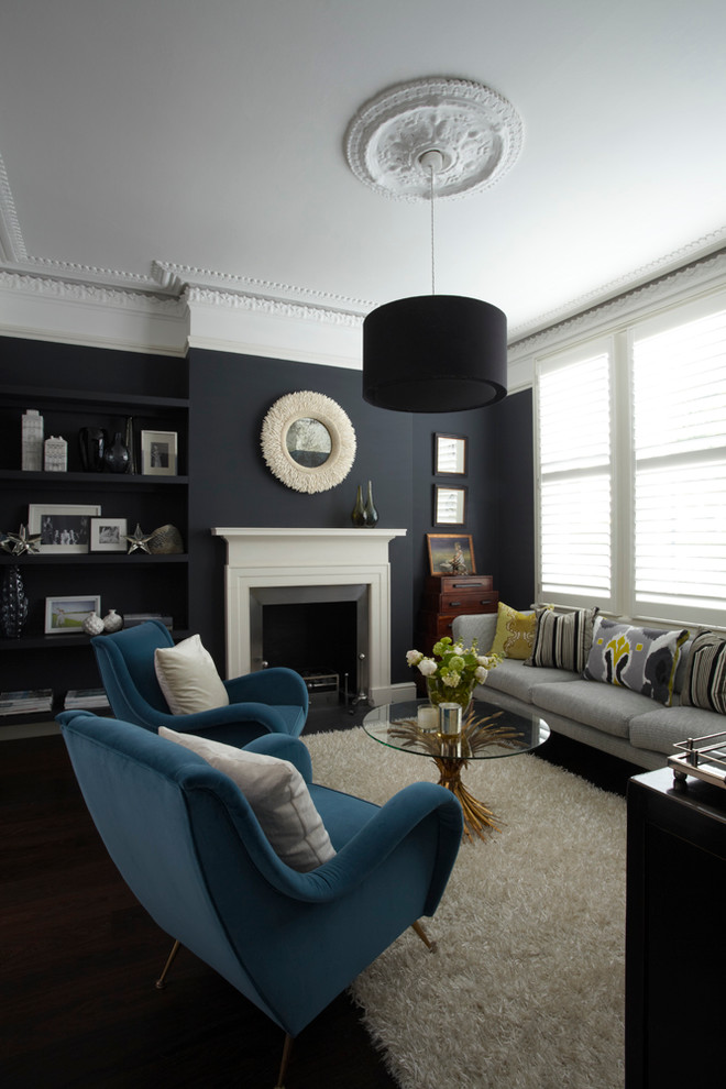 Mid-sized trendy formal living room photo in London with blue walls, a standard fireplace and no tv