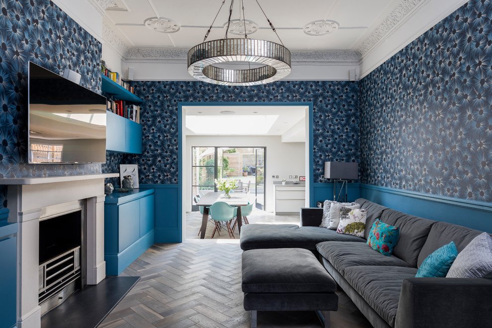 Ejemplo de salón clásico con paredes azules, suelo de madera oscura, televisor colgado en la pared y suelo marrón