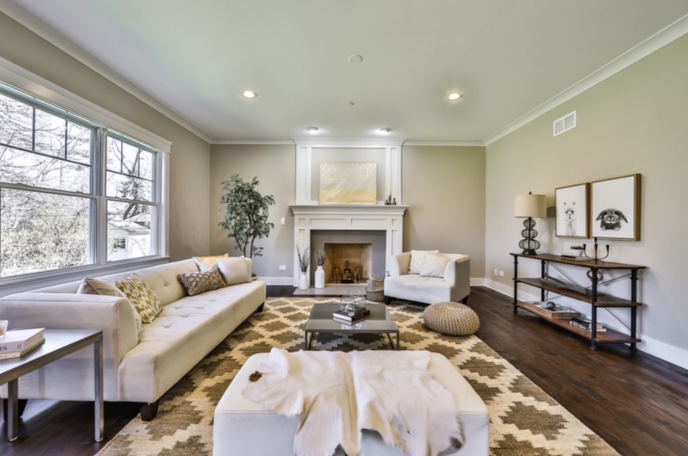 Photo of a large classic open plan living room in Chicago with beige walls, medium hardwood flooring, a standard fireplace, a stone fireplace surround, no tv and brown floors.