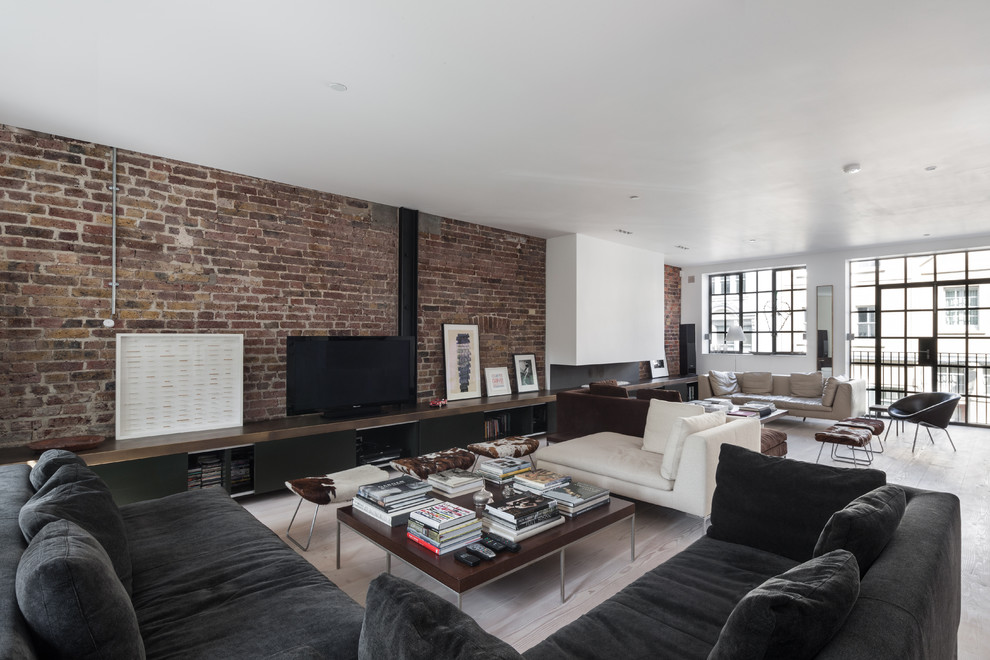 Huge urban open concept living room photo in London