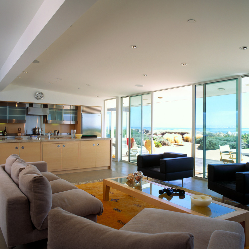 Example of a beach style concrete floor living room design in Santa Barbara