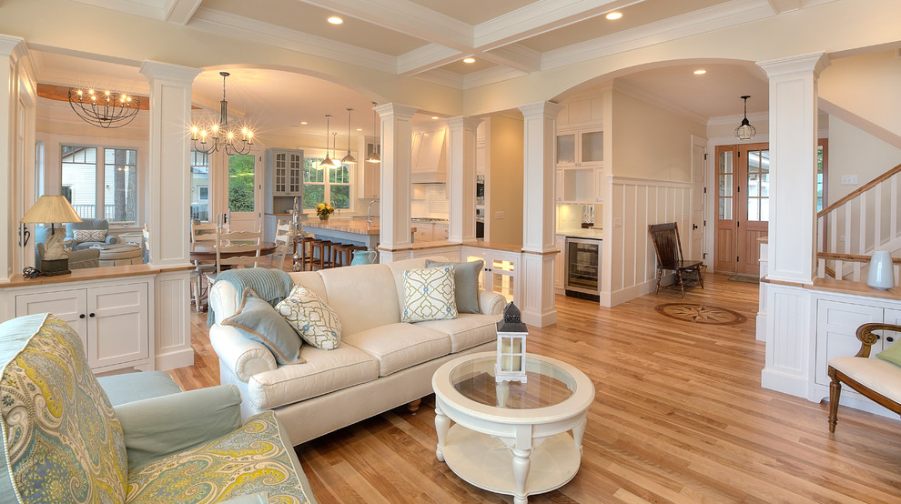 Example of a classic open concept living room design in Other with beige walls