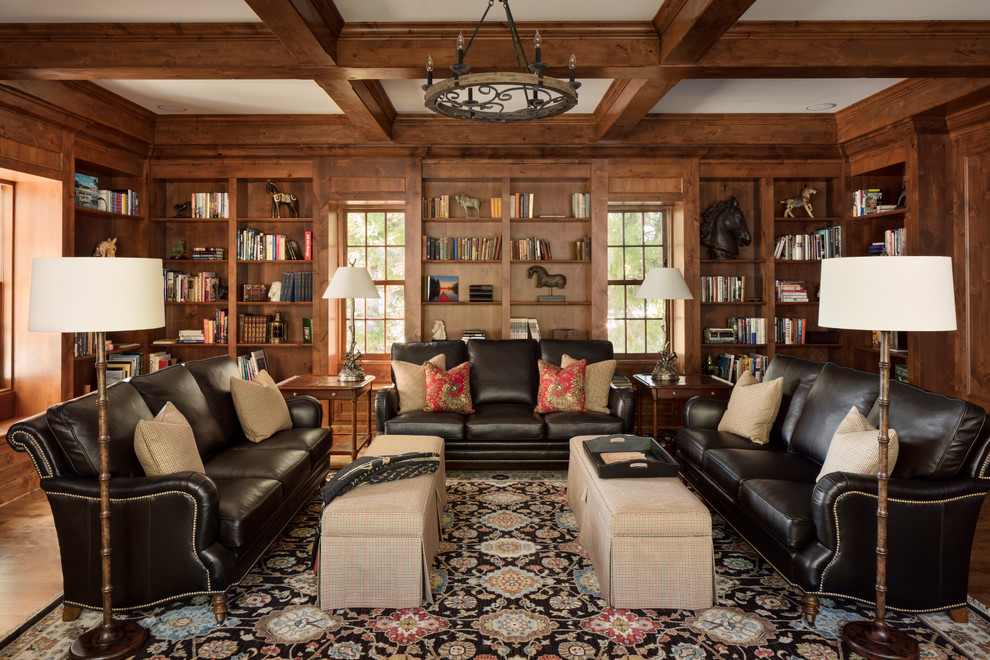 Living room library - country enclosed living room library idea in Milwaukee with brown walls