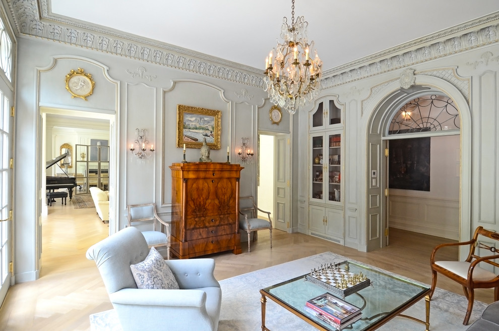 Foto de salón para visitas cerrado tradicional con paredes azules y suelo de madera clara