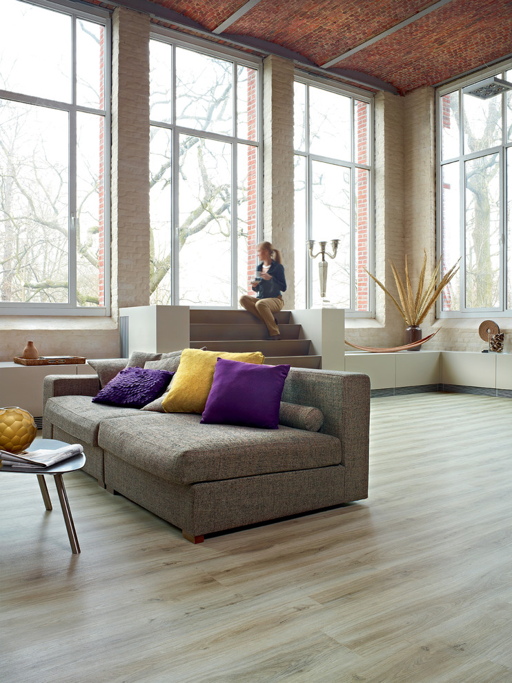 This is an example of an expansive modern open plan living room in Other.
