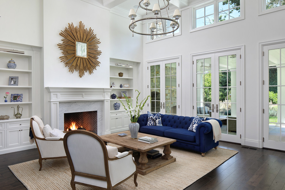 Example of a classic dark wood floor and brown floor living room design in San Francisco with white walls, a standard fireplace and a stone fireplace
