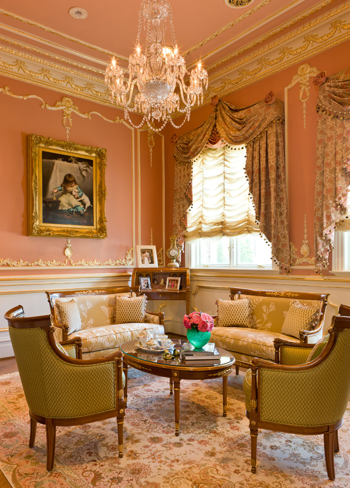 На фото: большая парадная, изолированная гостиная комната в викторианском стиле с розовыми стенами и паркетным полом среднего тона без камина, телевизора