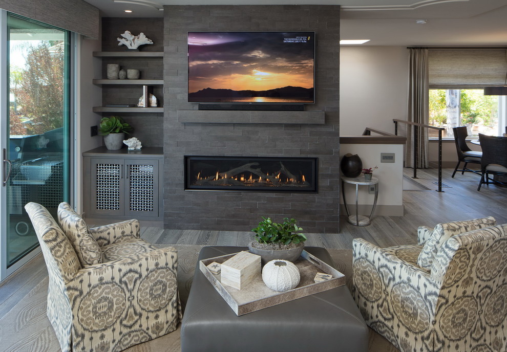 Inspiration for a medium sized traditional formal open plan living room in San Luis Obispo with white walls, light hardwood flooring, a ribbon fireplace, a tiled fireplace surround, a wall mounted tv and grey floors.