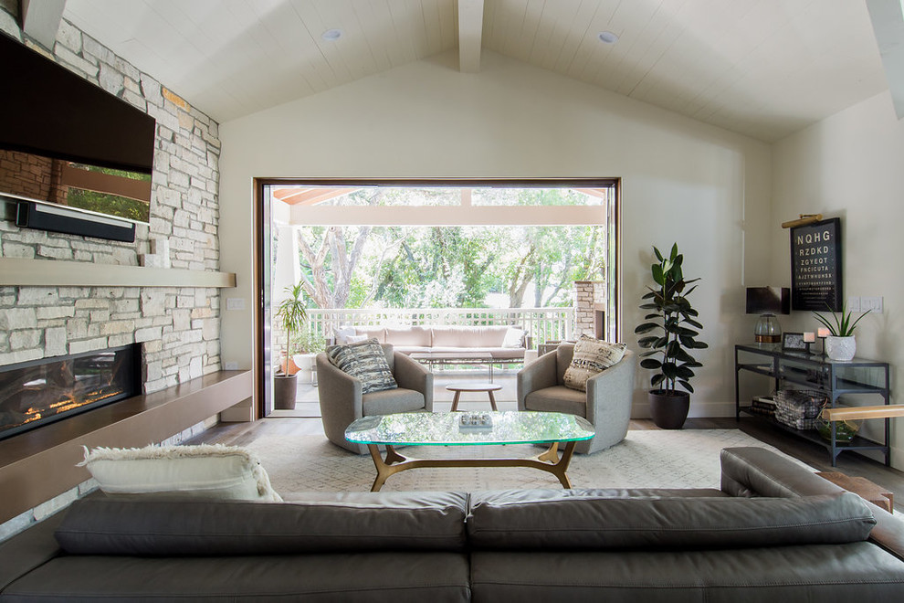 Design ideas for a medium sized classic enclosed living room in San Luis Obispo with white walls, a ribbon fireplace, a stone fireplace surround, a wall mounted tv, brown floors and dark hardwood flooring.