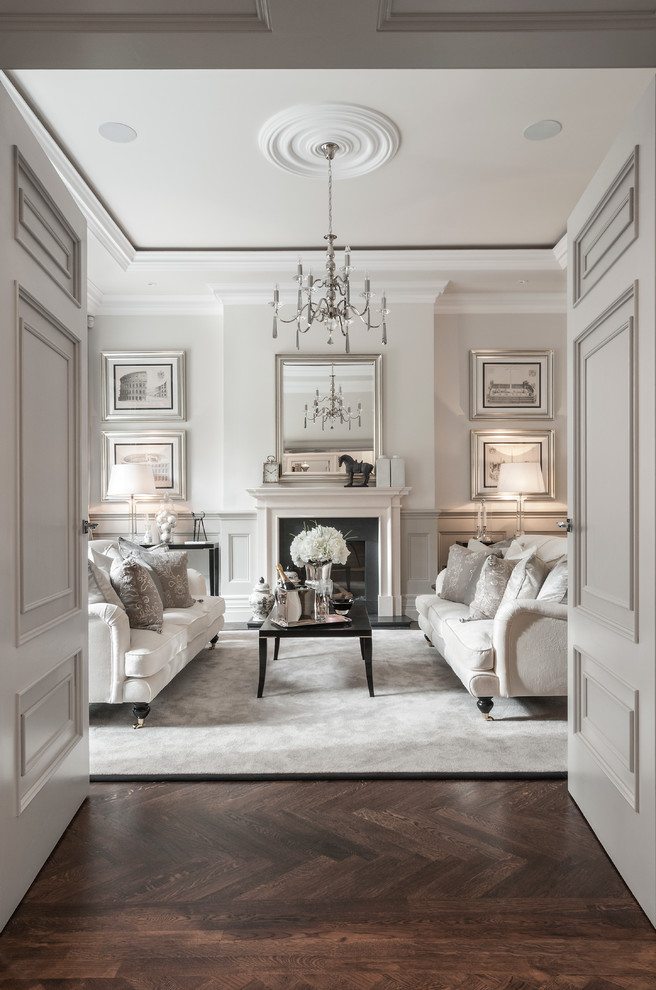 Inspiration for a traditional enclosed living room in Berkshire with dark hardwood flooring, a standard fireplace, brown floors and feature lighting.