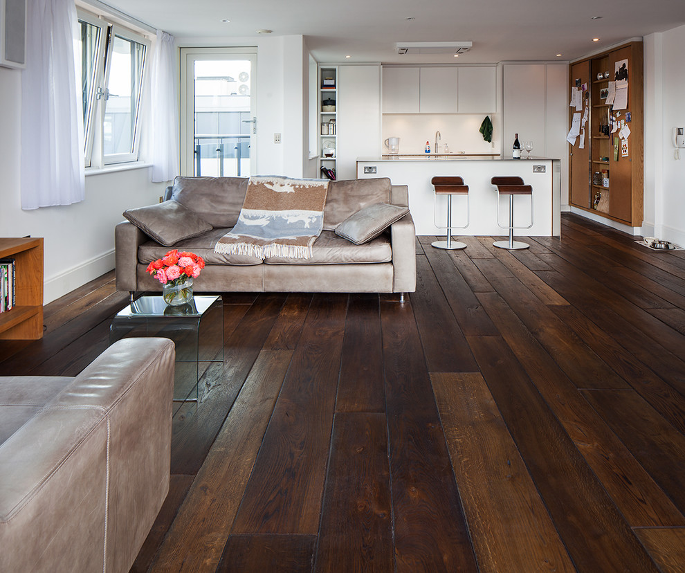 Living room - modern dark wood floor living room idea in London
