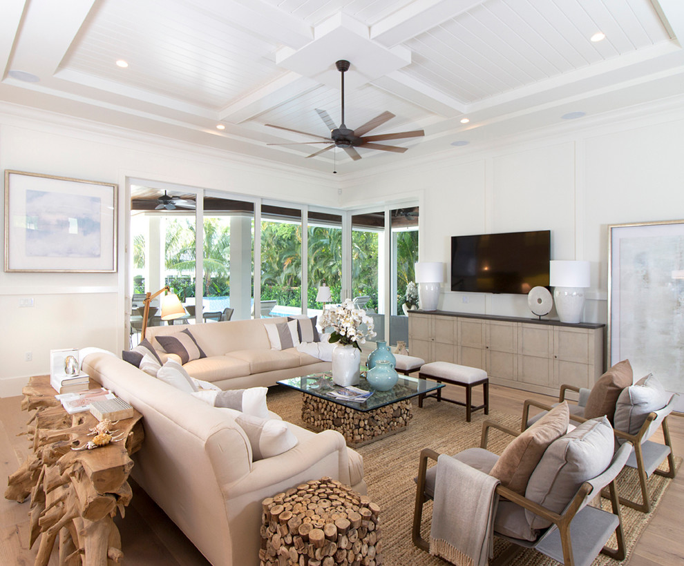 Large transitional light wood floor living room photo in Miami with white walls and a wall-mounted tv