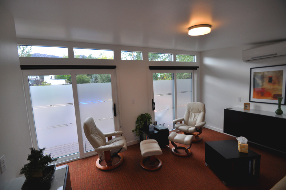 Foto di un ampio soggiorno minimalista chiuso con libreria, pareti bianche e moquette