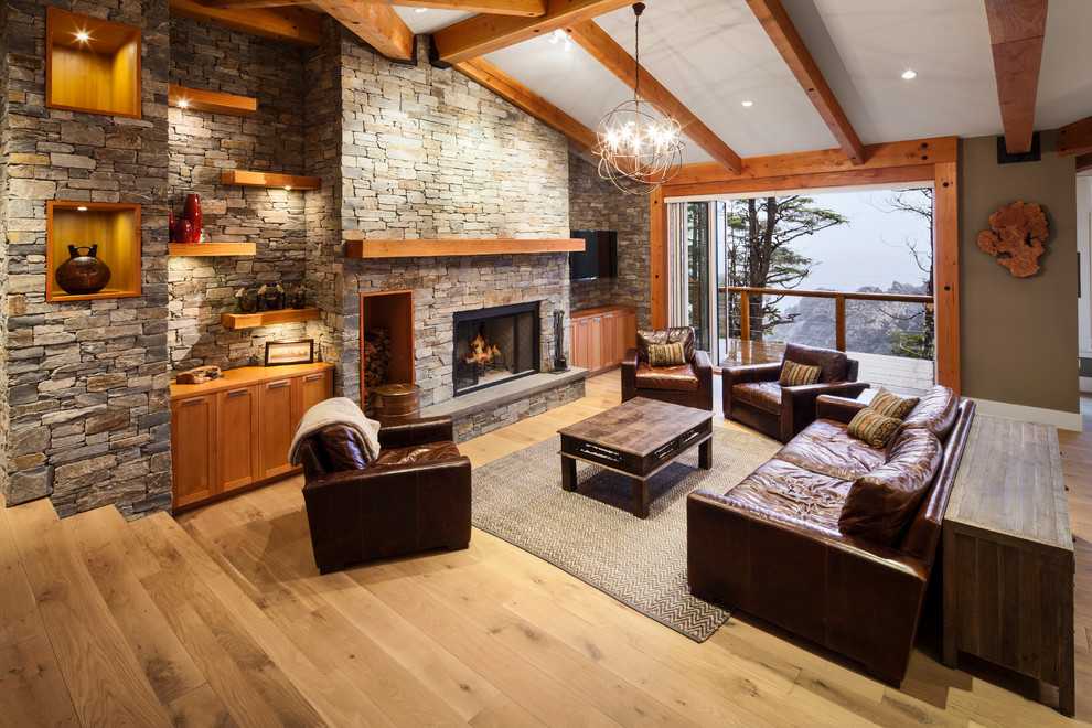 Living room - transitional living room idea in Vancouver with brown walls and a stone fireplace