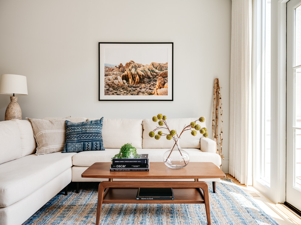 Inspiration for a scandinavian living room library remodel in San Francisco with white walls and no fireplace