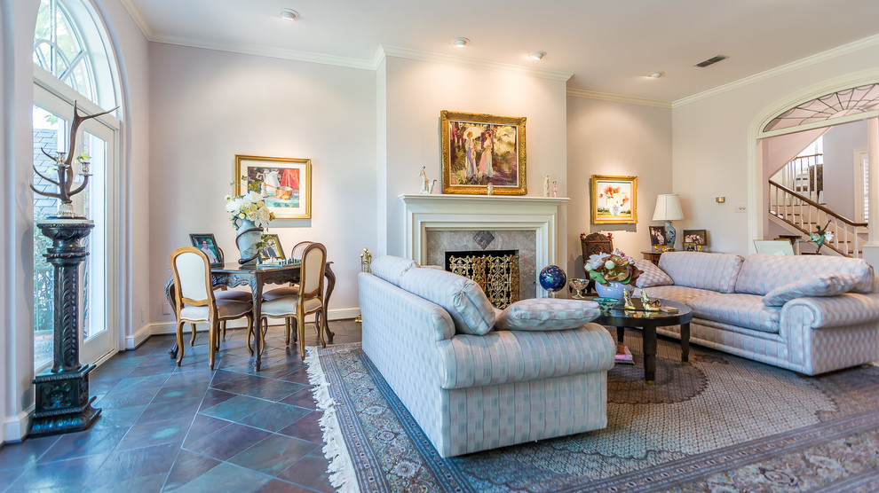 This is an example of a large traditional formal living room in Austin with slate flooring and a tiled fireplace surround.