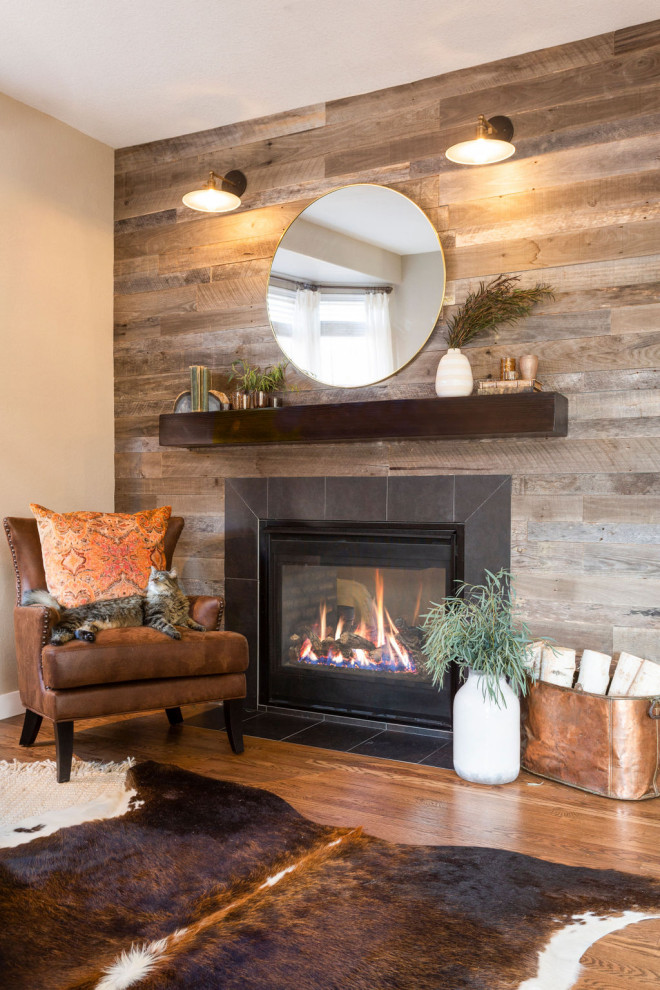Inspiration for a mid-sized transitional open concept medium tone wood floor and brown floor living room remodel in Denver with beige walls, a standard fireplace, a wood fireplace surround and a wall-mounted tv