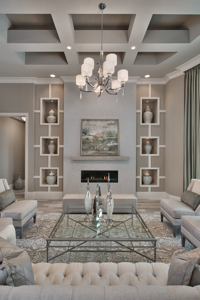 Пример оригинального дизайна: парадная гостиная комната в стиле неоклассика (современная классика) с серыми стенами, горизонтальным камином и ковром на полу