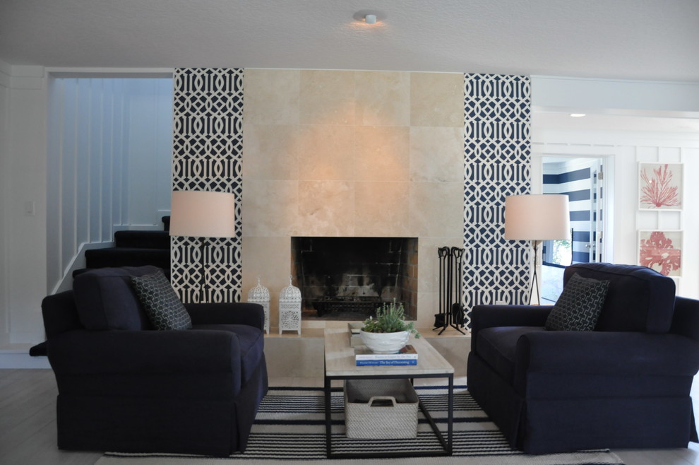 This is an example of a large beach style formal living room in Orlando with white walls, ceramic flooring, a standard fireplace and a tiled fireplace surround.