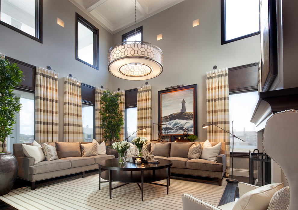 Пример оригинального дизайна: парадная, открытая гостиная комната:: освещение в стиле неоклассика (современная классика) с серыми стенами, темным паркетным полом и стандартным камином без телевизора