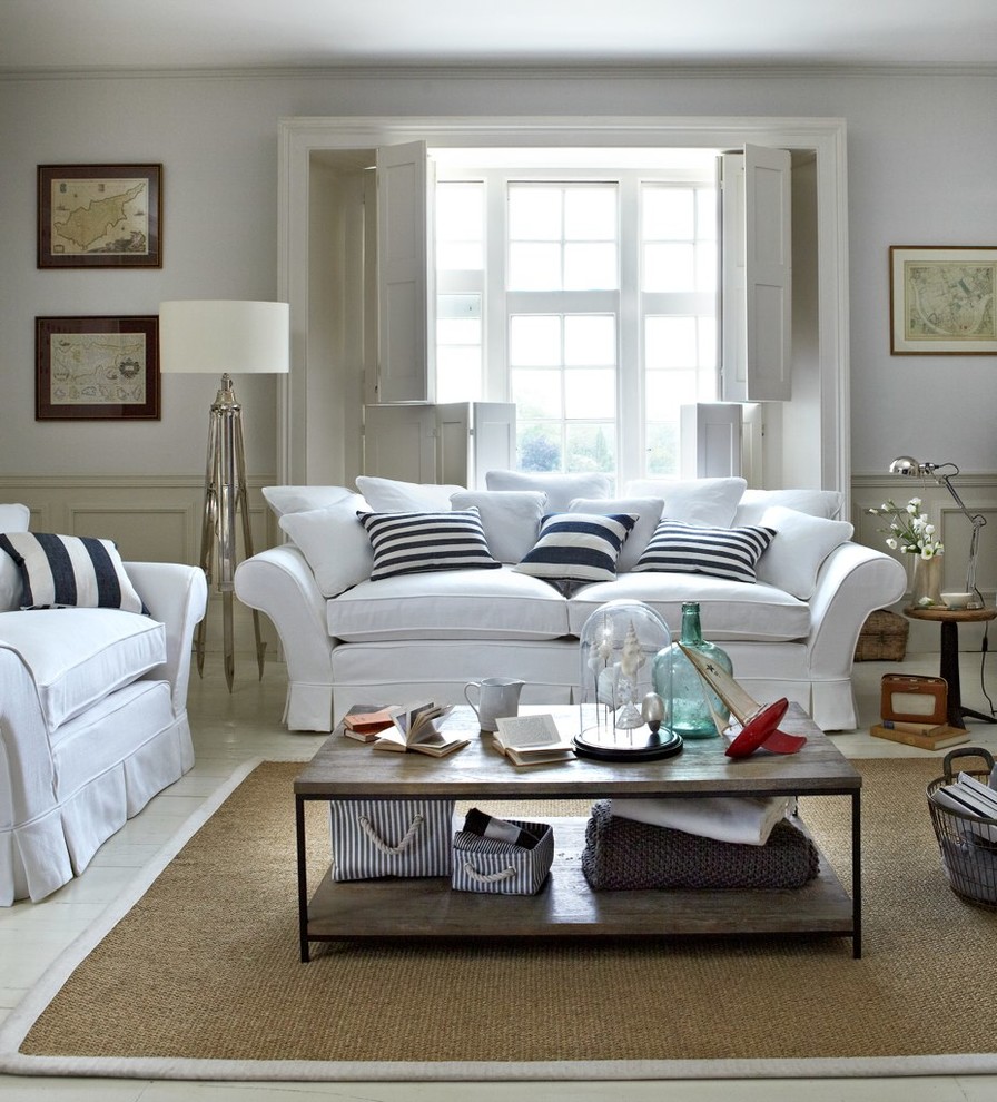 Design ideas for a large coastal open plan living room in London with painted wood flooring.