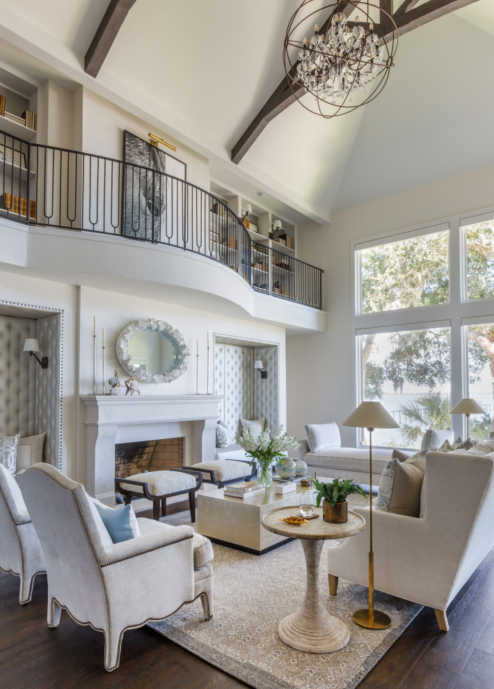 Example of a large transitional dark wood floor, brown floor and vaulted ceiling living room design in Jacksonville with white walls and a plaster fireplace