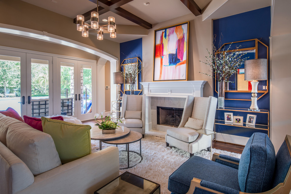 Example of a large transitional formal and open concept medium tone wood floor and brown floor living room design in Houston with blue walls, a standard fireplace and a tile fireplace