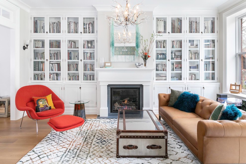 Inspiration for a transitional medium tone wood floor and brown floor living room remodel in New York with white walls and a standard fireplace