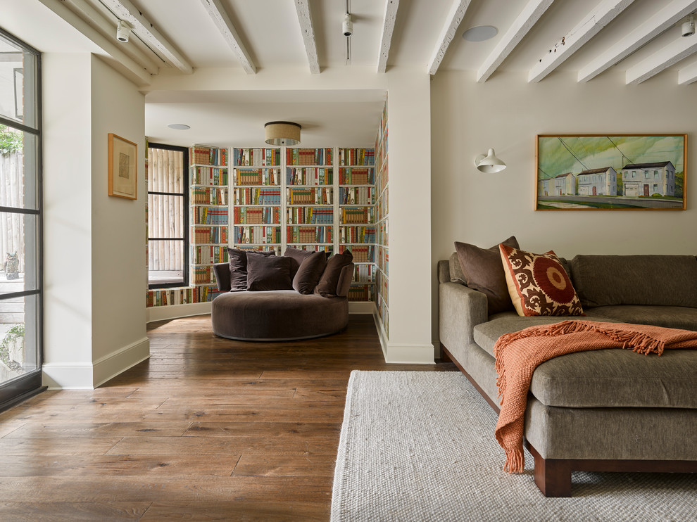 Источник вдохновения для домашнего уюта: гостиная комната в стиле неоклассика (современная классика) с с книжными шкафами и полками, разноцветными стенами, темным паркетным полом и коричневым диваном
