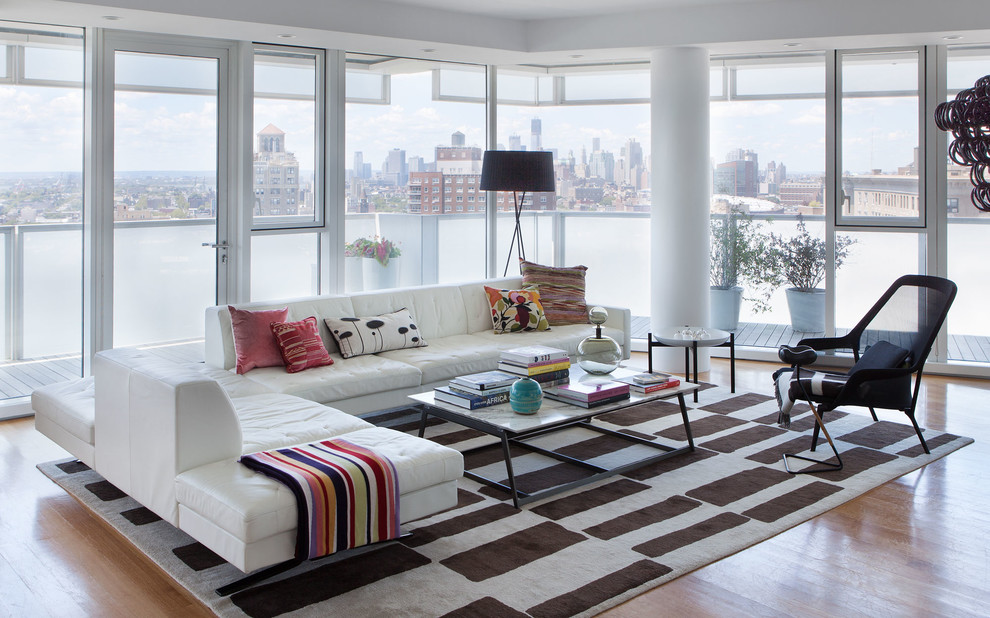 Design ideas for a modern open plan living room in New York with medium hardwood flooring.
