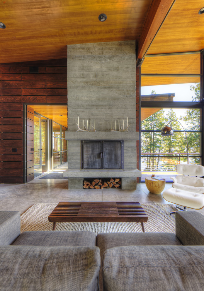 Minimalist living room photo in Seattle with a concrete fireplace