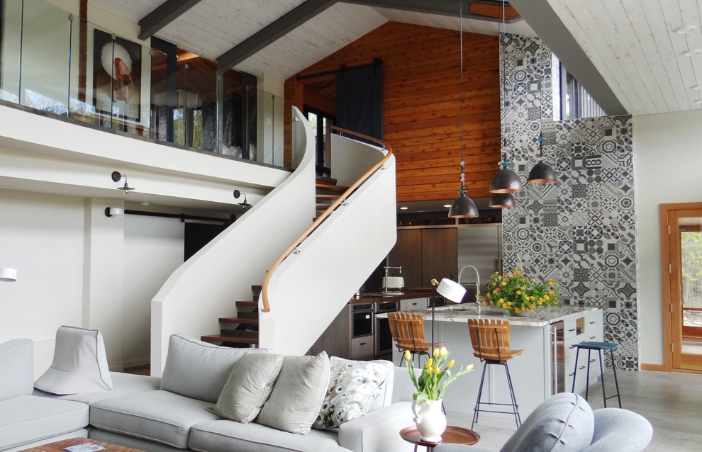 Esempio di un grande soggiorno contemporaneo aperto con pareti grigie, pavimento in cemento e pavimento grigio