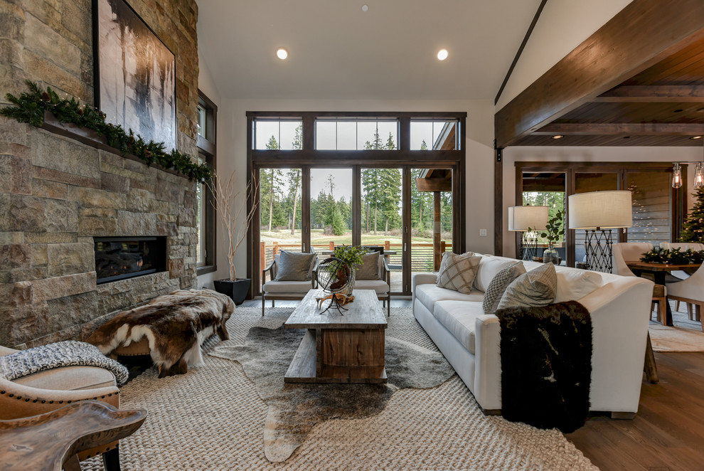 Photo of a rustic open plan living room in Seattle with white walls, dark hardwood flooring, a ribbon fireplace and grey floors.